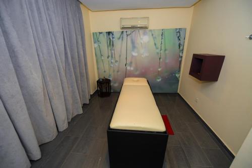 a bench in a room with curtains at Targafit Hotel & Hammam in Marrakech