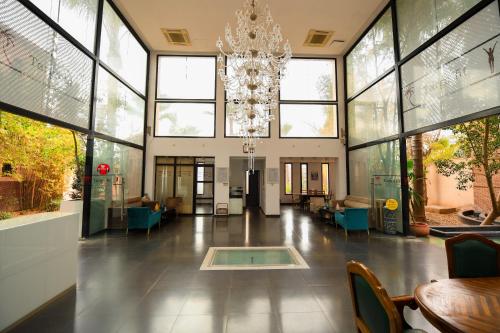 a large lobby with a chandelier and tables and chairs at Targafit Hotel & Hammam in Marrakech