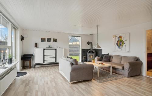 a living room with a couch and a table at Cozy Home In Skagen With Kitchen in Skagen