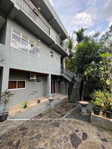 a house with a courtyard in front of it at Paddy Field Paradise by Sri Villa Rest in Hikkaduwa