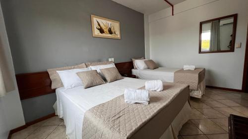 Ένα ή περισσότερα κρεβάτια σε δωμάτιο στο Hotel Portinari Ponte da Amizade