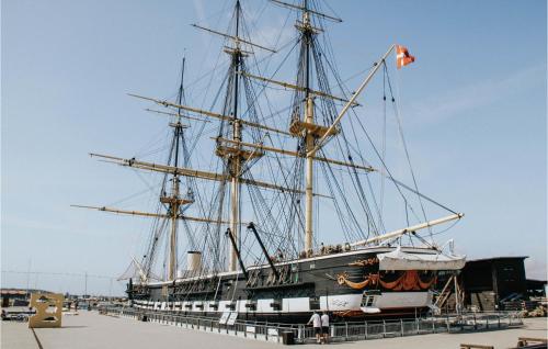 a large ship docked in a dock with a flag at 3 Bedroom Stunning Home In Ebeltoft in Ebeltoft