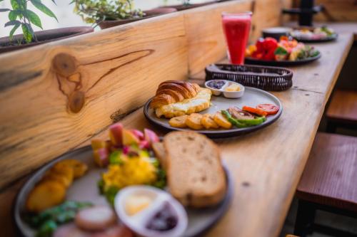 a table with plates of breakfast food on it at Thamel Heritage Hostel in Kathmandu