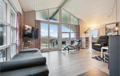 a living room with a couch and a tv at Cozy Home In Vestervig With Sauna in Vestervig