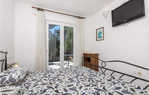 a bedroom with a bed and a flat screen tv at 3 Bedroom Nice Apartment In Cres in Cres