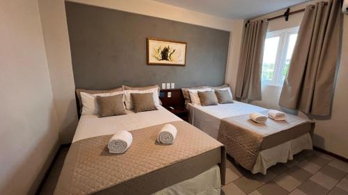 Ένα ή περισσότερα κρεβάτια σε δωμάτιο στο Hotel Portinari Ponte da Amizade