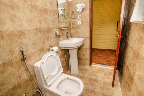 a bathroom with a toilet and a sink at Thamel Heritage Hostel in Kathmandu
