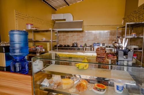 a restaurant kitchen with a counter with food at Thamel Heritage Hostel in Kathmandu
