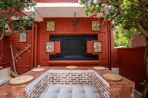 a brick fireplace in front of a brick wall at Thamel Heritage Hostel in Kathmandu