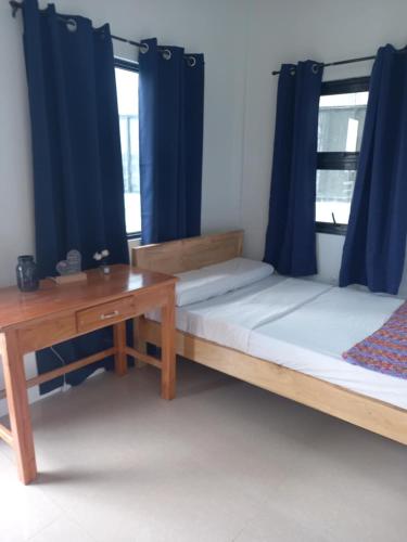 a room with two beds and a desk at The Soul Center in Batuan