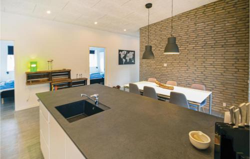 a kitchen and living room with a sink and a table at Four-Bedroom Holiday Home In Ebeltoft in Ebeltoft