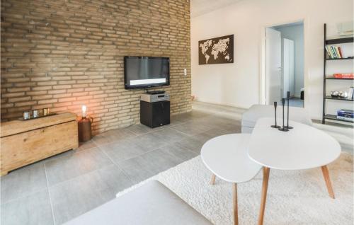 a living room with a brick wall at Four-Bedroom Holiday Home In Ebeltoft in Ebeltoft