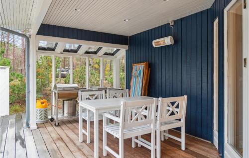 a dining room with a white table and chairs at Stunning Home In Nexø With Kitchen in Vester Sømarken