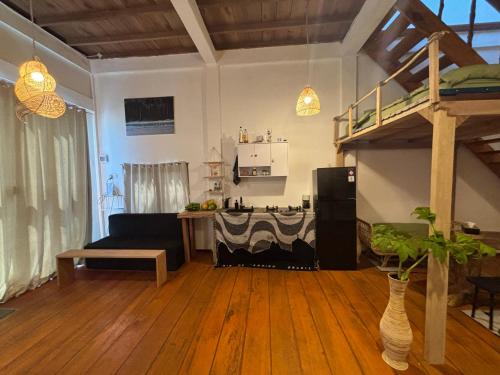 a living room with a couch and a bunk bed at Valhalla Mentawai in Katiet