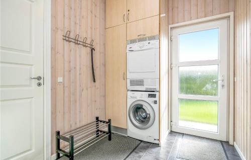 a laundry room with a washing machine and a window at Holiday Home Toftevej in Løkken