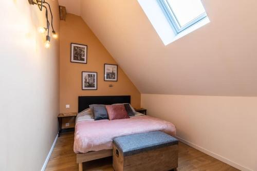 a bedroom with a bed and a skylight at Gîte Cosy Jacuzzi privatif proche Paris et Giverny in La Boissière