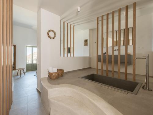 a bathroom with a large bath tub in a room at Saluti Da Stampalia Chora in Pera Gyalos