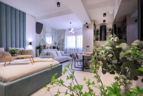 a bedroom with a bed and a living room at AIASTAY Bucharest River Apartments in Bucharest