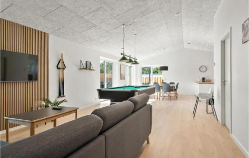 a living room with a couch and a pool table at Gorgeous Home In Ebeltoft With Sauna in Ebeltoft