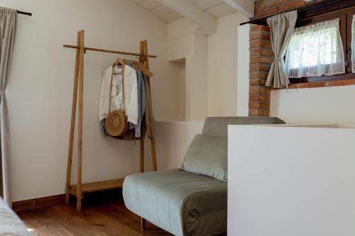 a small bedroom with a bed and a window at El Molino de Bonaco in San Vicente de la Barquera