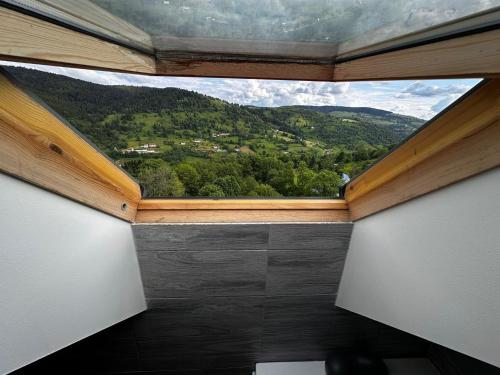 a window in a room with a view of a mountain at Chalet Bois de Rose in La Bresse