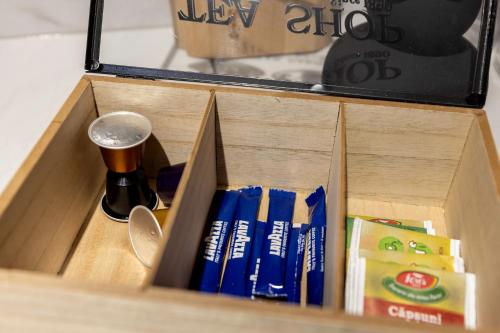 a wooden box with books and a cup in it at AIASTAY Bucharest River Apartments in Bucharest