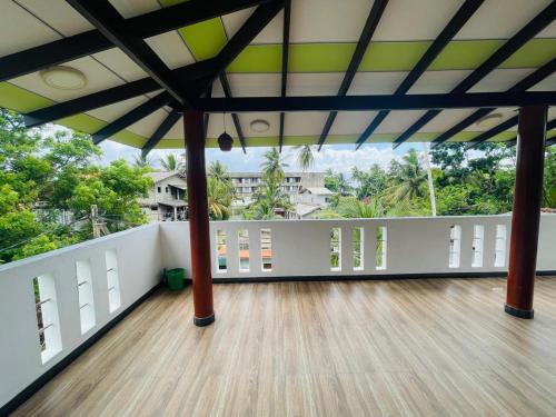 a large room with a wooden floor and a large ceiling at Mindiya Turtle Waves Talalla in Talalla