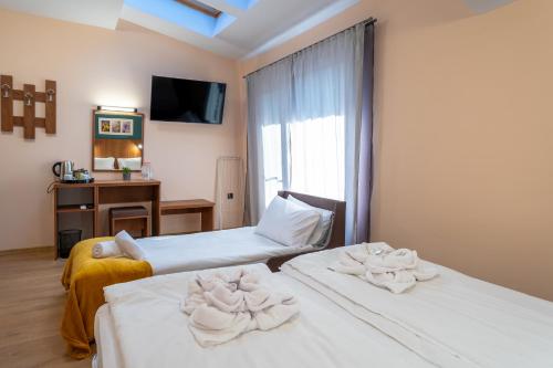 Ένα ή περισσότερα κρεβάτια σε δωμάτιο στο Simada Center Guesthouse