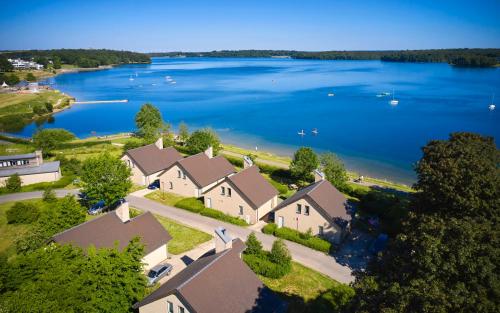 an aerial view of a house with a lake at Landal Village Leau Dheure in Froid-Chapelle