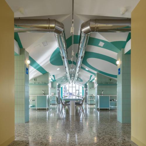 a room with blue and green ceilings and pipes at Loop INN Hostel Santiago de Compostela in Santiago de Compostela
