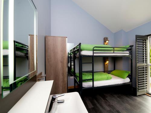 a bathroom with bunk beds and a sink at YHA Boggle Hole in Fylingthorpe