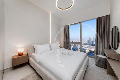 Un ou plusieurs lits dans un hébergement de l'établissement Prime Burj Khalifa&Fountain Views 2 Bdr Apartment