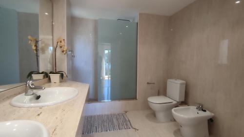 a bathroom with a sink and a toilet and a shower at VILLAS COSETTE Villa Cami de les Penyes in GRO