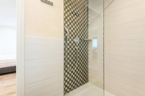 a shower with a glass door in a bathroom at Haus Christianenhöhe, Whg 09 Capper in Westerland (Sylt)