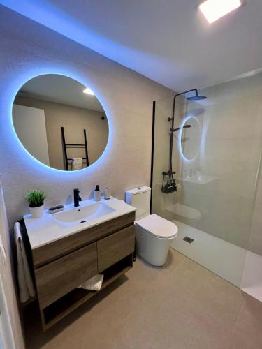 a bathroom with a sink and a toilet and a mirror at Villa de Béjar in Béjar