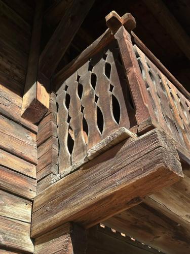 a wooden bench with a design on it at Casa Vanellus / Vignogn / Val Lumnezia / near Laax in Vigens