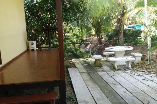 a patio with a table and a picnic table at Ruentonnum Amphawa in Amphawa