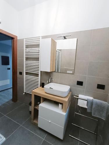 a bathroom with a sink and a mirror at Casa del Cerbiatto, Lake Como a 5 chilometri da Argegno in Castiglione dʼIntelvi