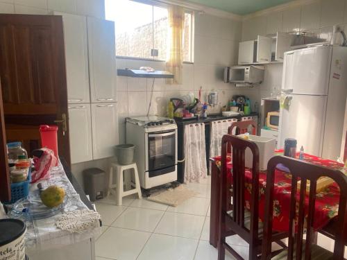 a kitchen with a stove and a refrigerator at Refugio da Marvila in Marataizes