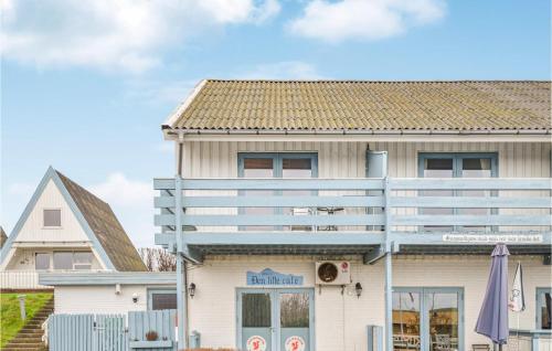 a white house with a brown roof at One-Bedroom Apartment In Knebel in Knebel