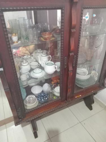 a cabinet full of dishes and cups and plates at Cantinho do lazer in Niterói