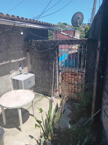 a patio with a table and a heater and a table at Cantinho do lazer in Niterói