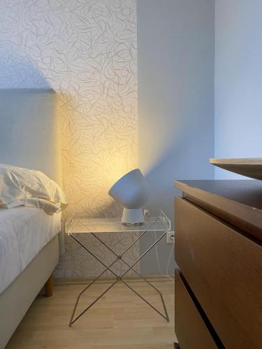 a bedroom with a bed and a chair next to a dresser at Villa Green in Sliač