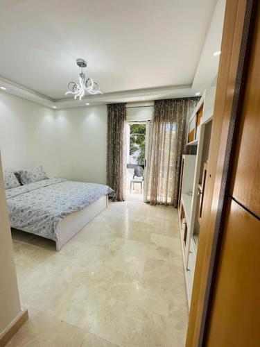 a bedroom with a bed and a television in it at villa pour location vacances in Tamaris