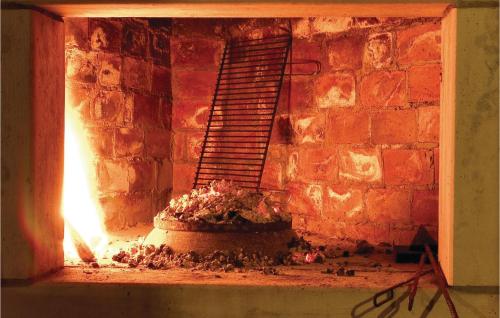 a brick oven with a fire inside of it at Lovely Home In Podstrana in Podstrana