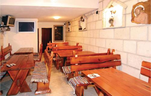 a dining room with wooden tables and chairs at Lovely Home In Podstrana in Podstrana