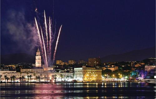 a fireworks display over a city at night at Lovely Home In Podstrana in Podstrana