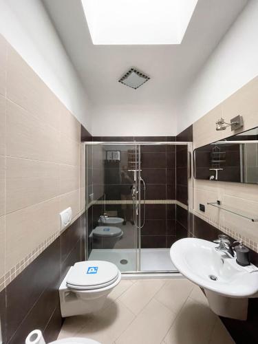 a bathroom with a shower and a toilet and a sink at InCorteDaFabio Design flat with Bikes in Caronno Pertusella