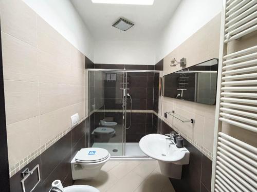 a bathroom with two toilets and a shower and a sink at InCorteDaFabio Design flat with Bikes in Caronno Pertusella