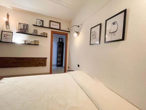 a bedroom with a bed and some pictures on the wall at InCorteDaFabio Design flat with Bikes in Caronno Pertusella
